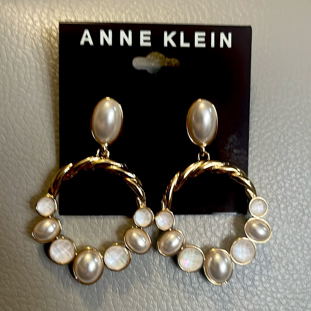Anne Klein gold tone mother of pearl orbital earrings.
